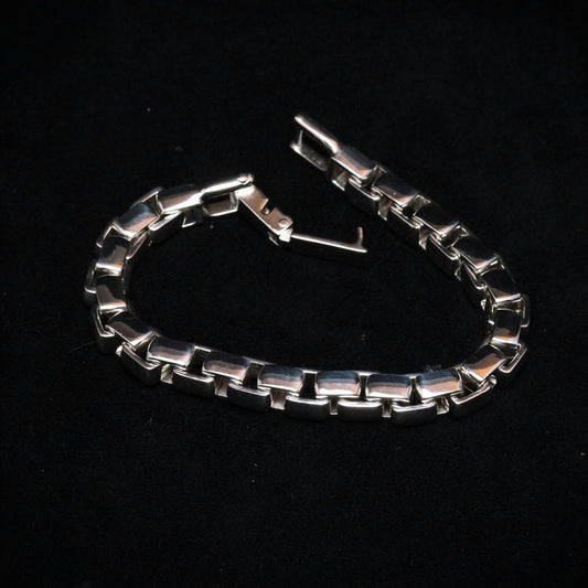 Silver chain bracelet on a black background
