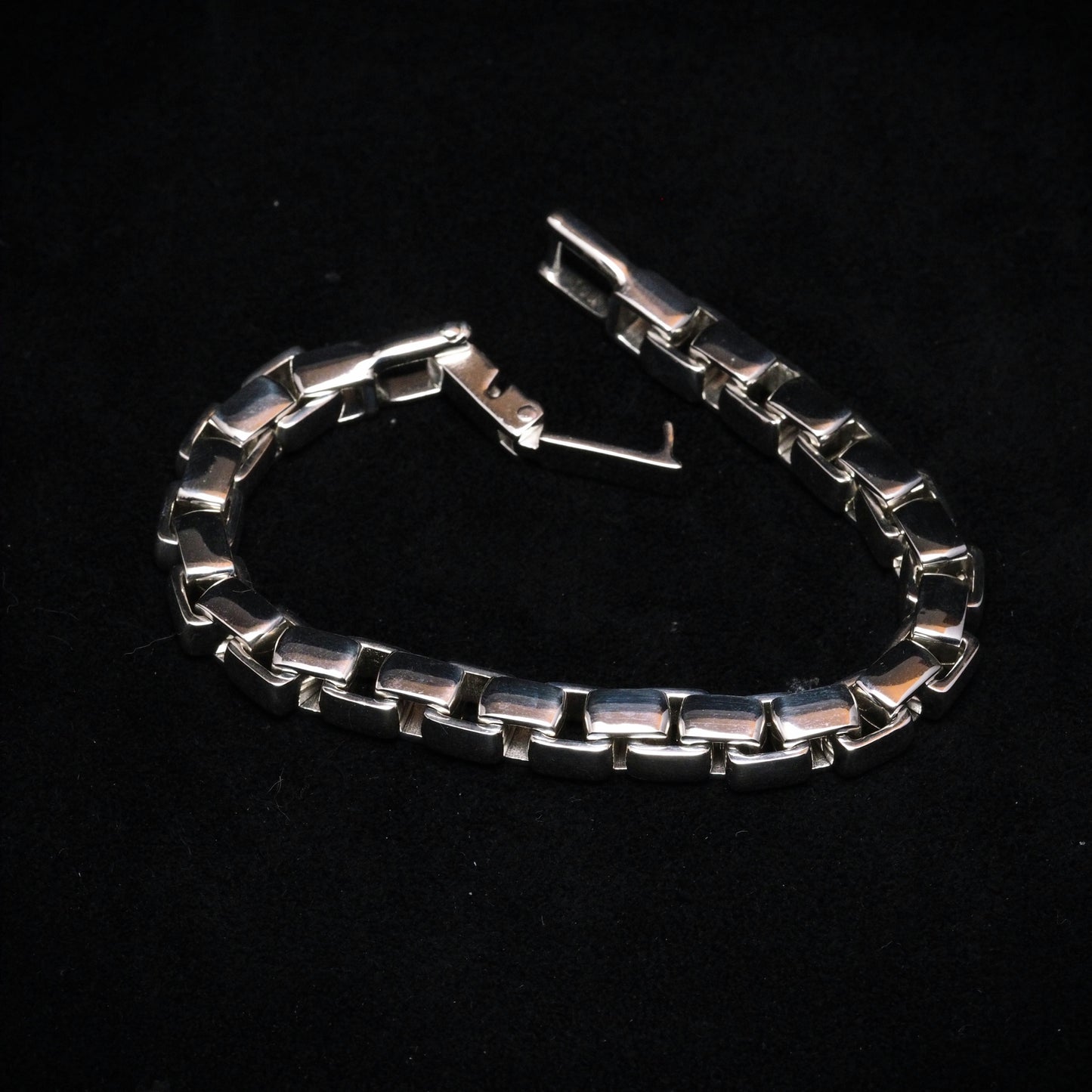 Silver chain bracelet on a black background